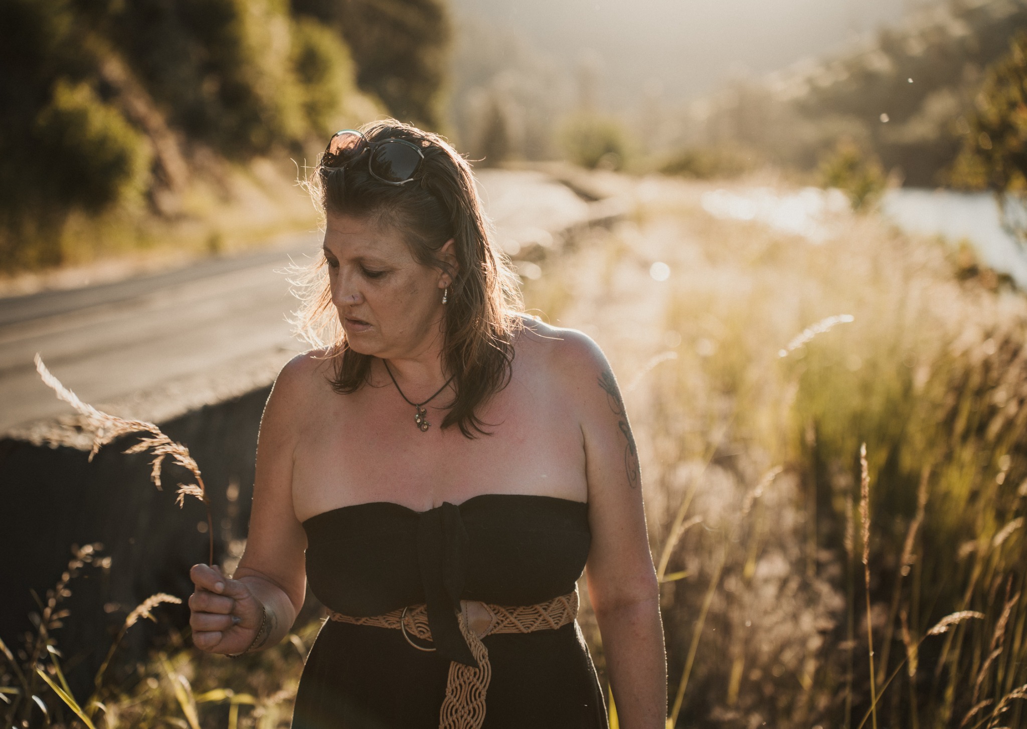 A woman beside the river in evening light