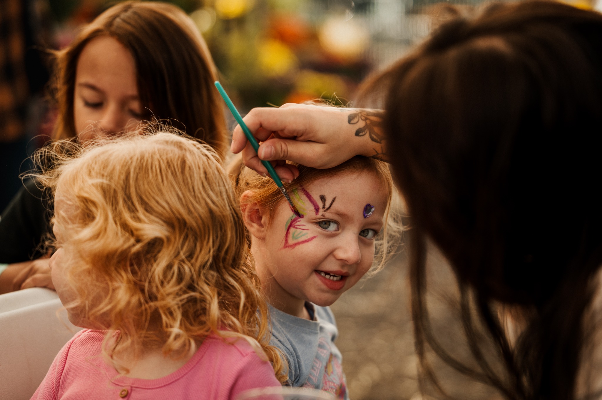 A child having her face painted